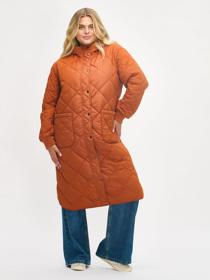 Chelsea | Women’s long quilted hooded coat with oversized patch pockets