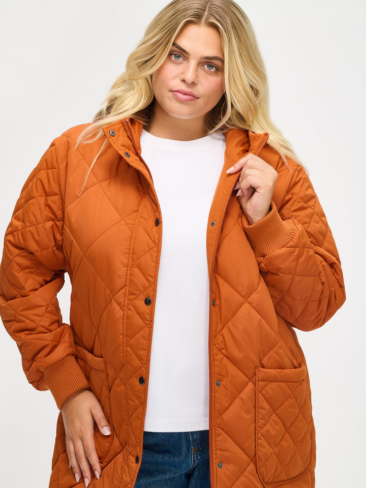 Chelsea | Women’s long quilted hooded coat with oversized patch pockets