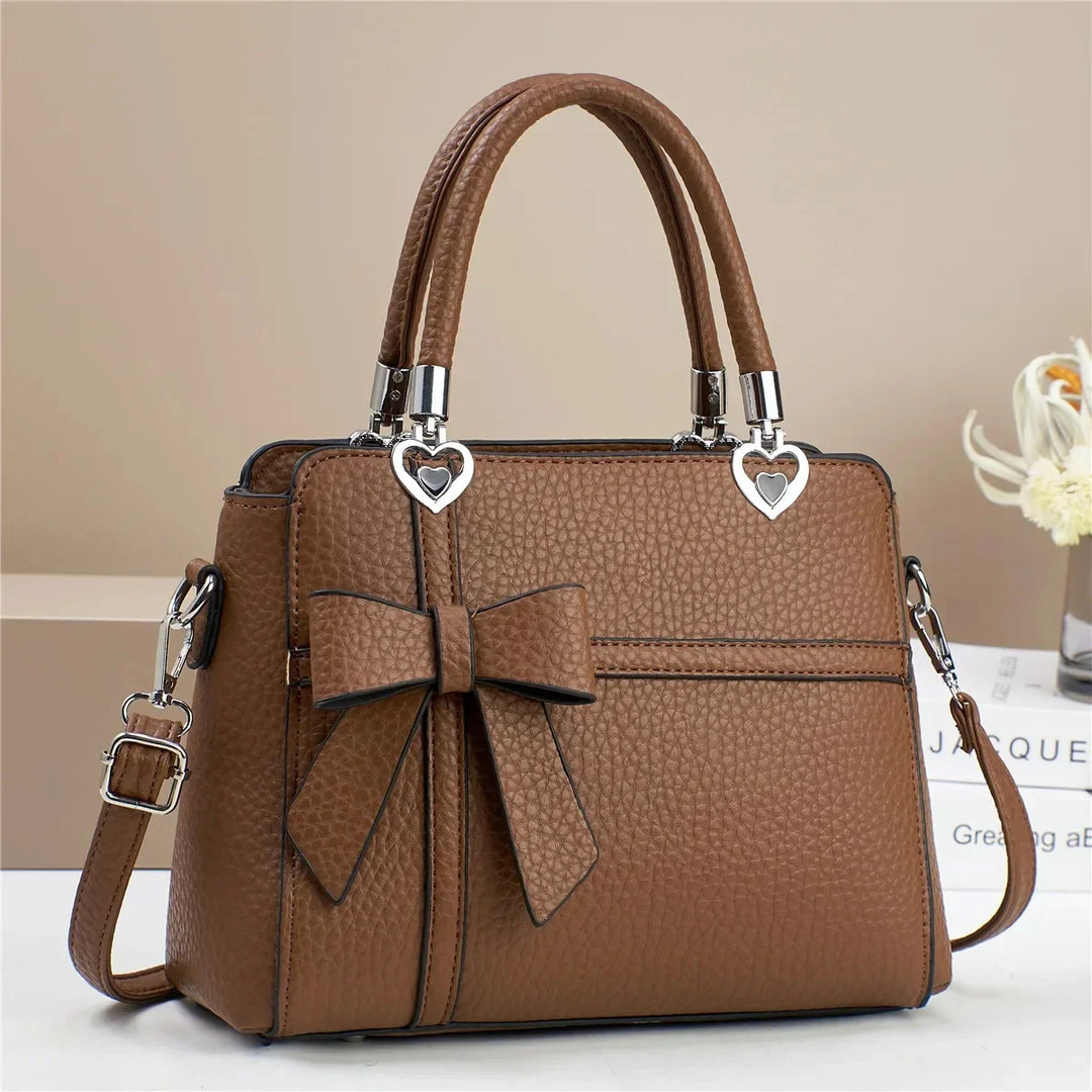 Tamara | Women’s faux leather handbag with bow and heart accents
