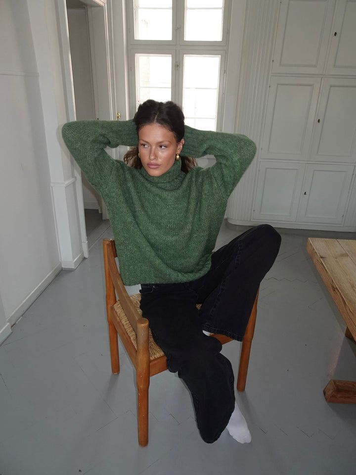 Kris | Women’s green turtleneck sweater with ribbed details and sleek silhouette