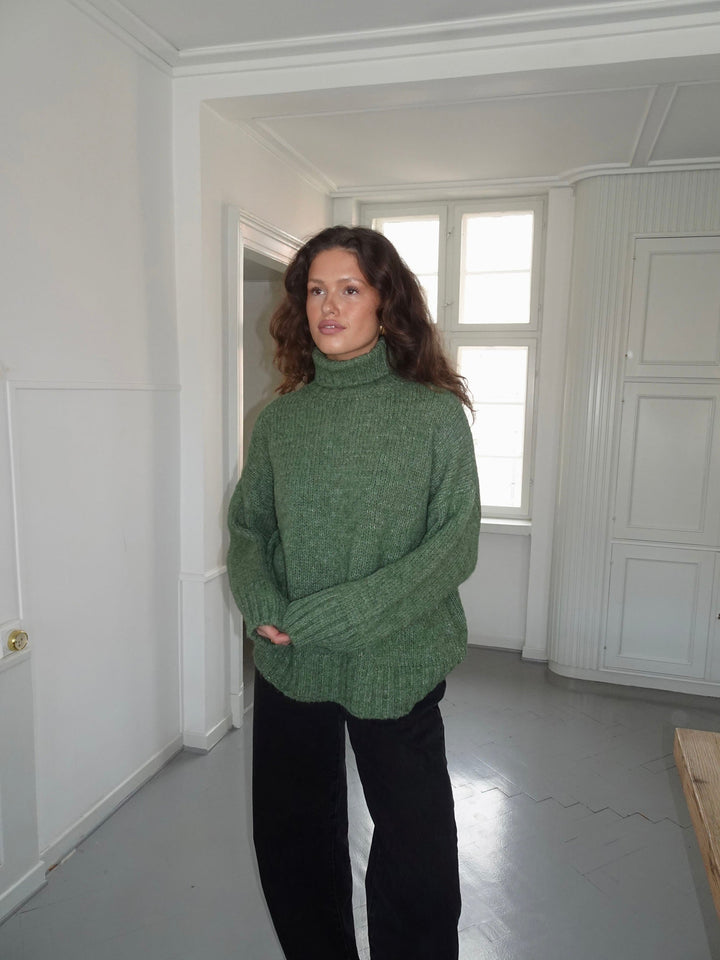 Kris | Women’s green turtleneck sweater with ribbed details and sleek silhouette